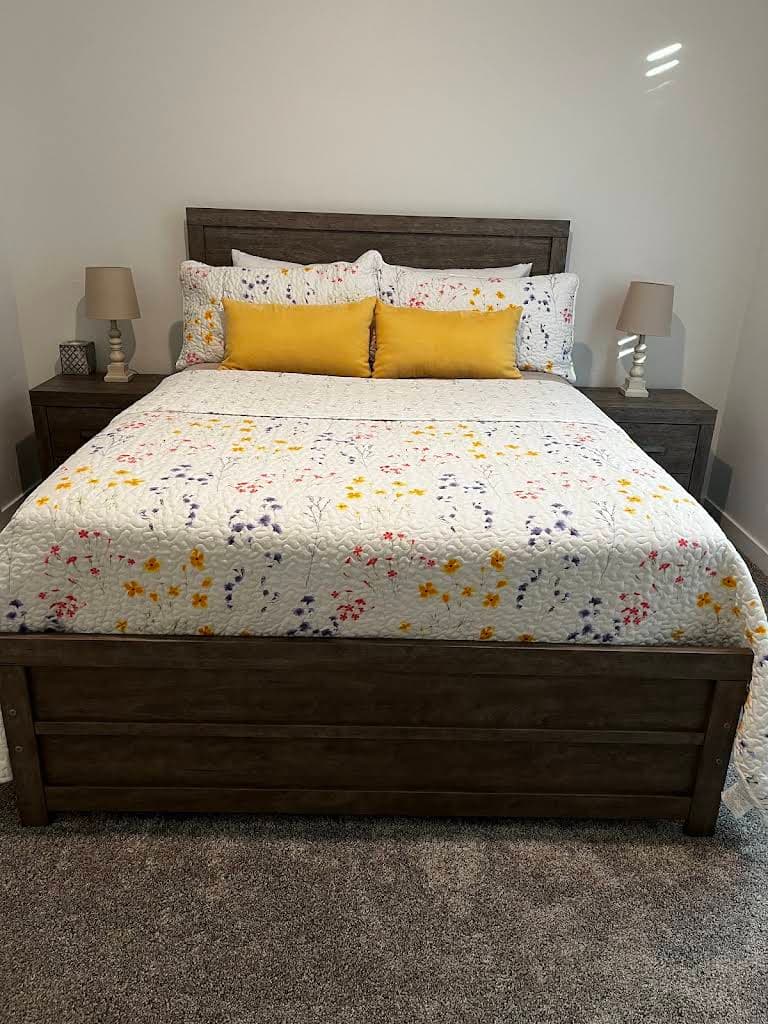 Professionally made bed in a tidy bedroom after cleaning