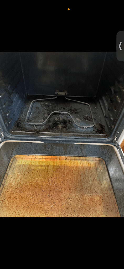 Oven interior before cleaning, covered in baked-on grease and residue